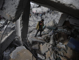 A Palestinian man inspects the rubble of a building destroyed in an Israeli airstrike in Rafah in the southern Gaza Strip