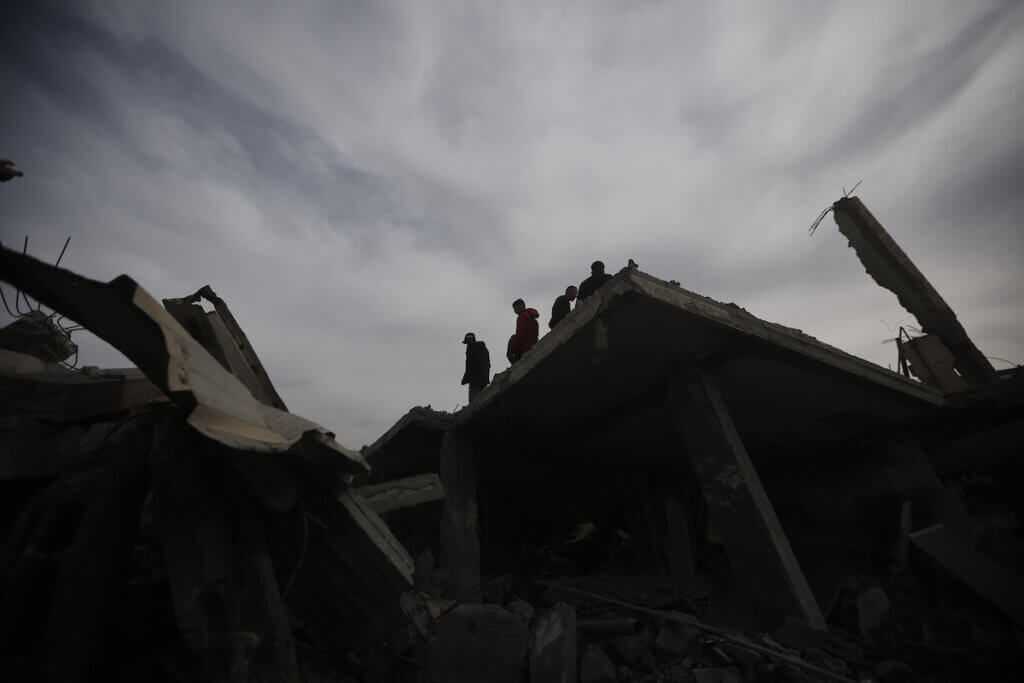 Palestinians inspect the rubble of a building where two Israeli captives were reportedly held before being rescued during an Israeli security forces operation in Rafah, in the southern Gaza Strip on February 12, 2024. (Photo: Bashar Taleb/APA Images)