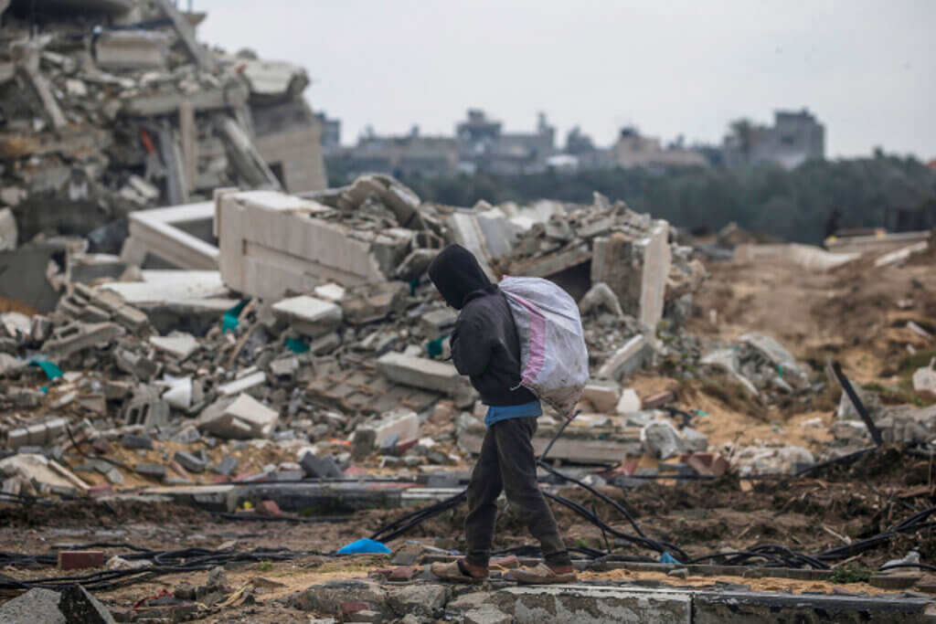 A Palestinian passes a destroyed building during an Israeli military operation in the al-Nuseirat refugee camp in southern Gaza, February 19, 2024. (Photo: © Mohammed Saber/EFE via ZUMA Press APA Images)
