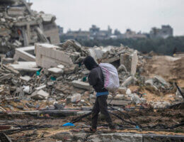 A Palestinian passes a destroyed building during an Israeli military operation in the al-Nuseirat refugee camp in southern Gaza, February 19, 2024. (Photo: © Mohammed Saber/EFE via ZUMA Press APA Images)