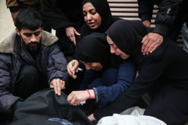 Palestinian women grieve over the bodies of their loved ones killed in Israeli airstrikes in Deir Al-Balah, in the central Gaza Strip.