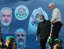 Yahya Sinwar, leader of the Palestinian Hamas movement, greets supporters during a rally in Gaza City on May 24, 2021. Behind Sinwar hangs a banner with current and former Hamas leaders Ismail Haniyeh, Khaled Mashal, and Sheikh Ahmed Yassin. (Photo: Ashraf Amra/APA Images)