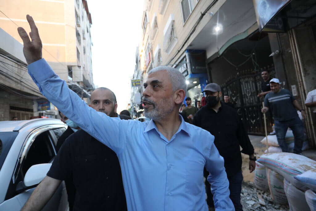 Yahya Sinwar, leader of the Palestinian Hamas movement's political wing, greets supporters as he tours the Al-Rimal neighbourhood in Gaza City, on May 26, 2021, to assess the damaged caused during the recent bombing by Israeli forces. (Photo: Ashraf Amra/APA Images)
