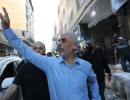 Yahya Sinwar, leader of the Palestinian Hamas movement's political wing, greets supporters as he tours the Al-Rimal neighbourhood in Gaza City, on May 26, 2021, to assess the damaged caused during the recent bombing by Israeli forces. (Photo: Ashraf Amra/APA Images)