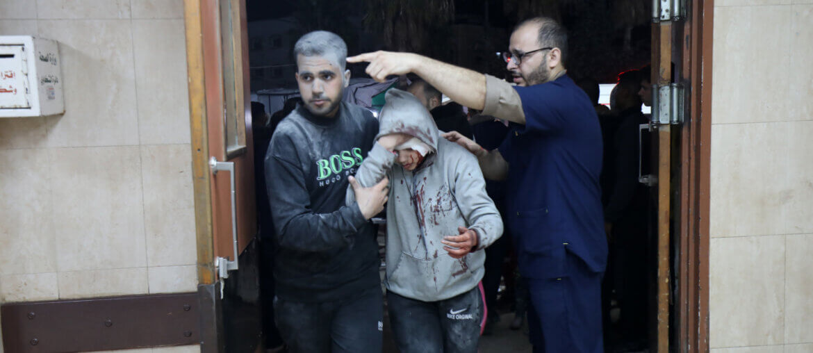 Injured Palestinains covered in dust enter the Al-Aqsa Martyrs Hospital in Deir al-Balah in the central Gaza Strip following Israeli airstrikes on homes in the area.