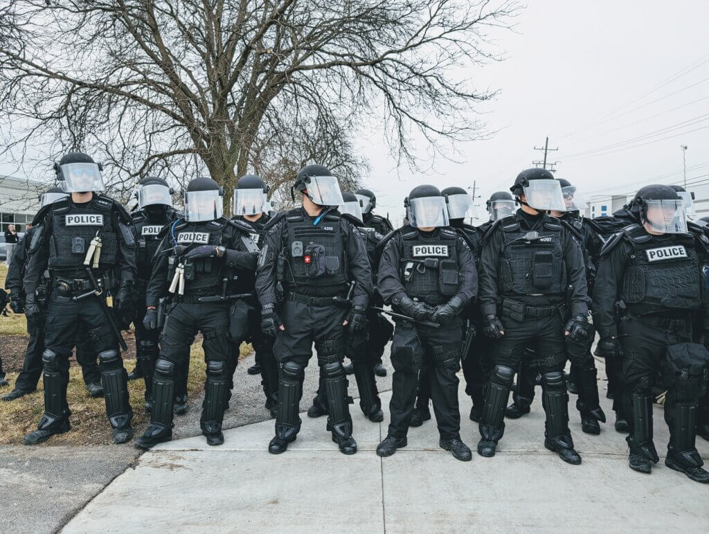 A phalanx of riot policy officers waiting to make arrests outside of the Woodward MPC manufacturing facility in Niles, Illinois, February 7, 2024. (Photo: Instagram/@jeegheel)