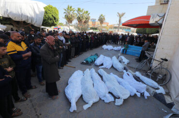 Palestinians over the bodies of people killed during an Israeli airstrike in Deir al-Balah in the central Gaza Strip, March 12, 2024. (Photo: Naaman Omar/APA Images)