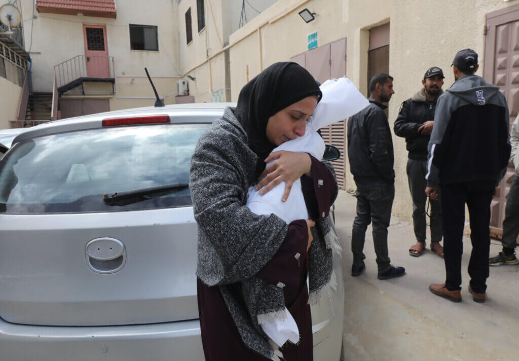 Relatives of Palestinian baby Bassam al-Maquse, who was killed in Israeli attacks, mourn as they receive the his body from the morgue of Al-Aqsa Hospital for burial in Deir al-Balah, central Gaza, March 22, 2024. (Photo: Ali Hamad/APA Images)