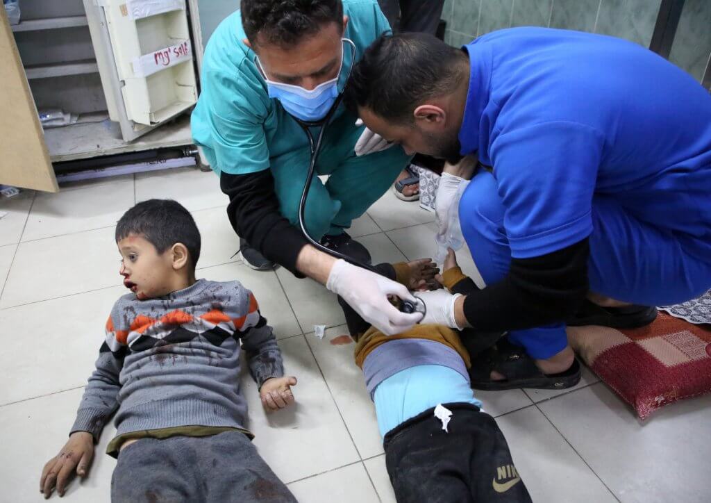Two injured Palestinian children are being treated by doctors on the floor of a hospital in southern Gaza, following Israeli airstrikes.