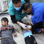 Two injured Palestinian children are being treated by doctors on the floor of a hospital in southern Gaza, following Israeli airstrikes.