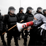 Police block protestors during a rally for a cease fire in Gaza outside a UAW union hall during a visit by President Joe Biden in Warren, Michigan, Feb. 1, 2024. (Photo: Rebecca Cook/Reuters)