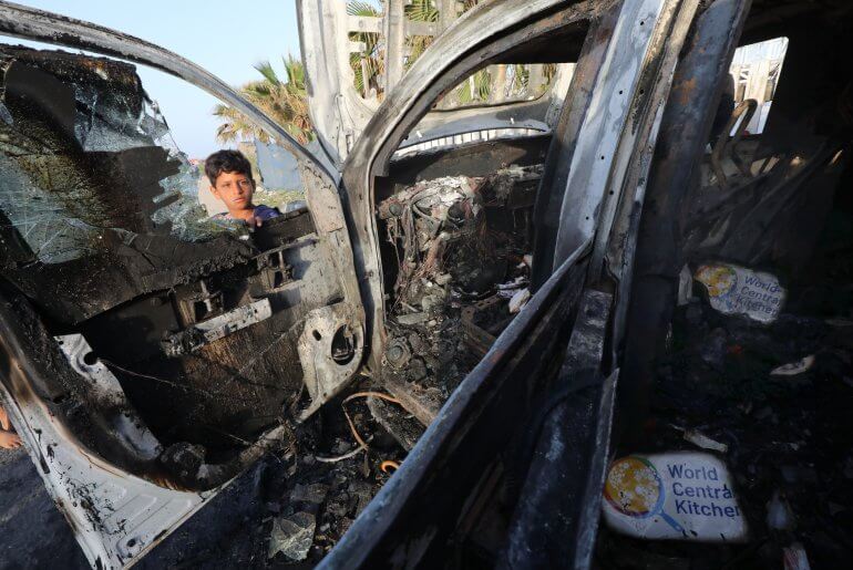 Palestinians inspect the damaged vehicles of the World Central Kitchen after the Israeli attack that killed seven of its workers in Deir al-Balah, April 2, 2024. (Photo: Omar Ashtawy/APA Images)