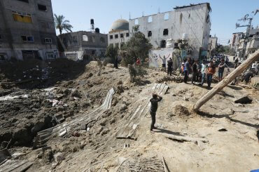 Palestinians inspect the damage and recover items from their destroyed homes following Israeli air strikes on Deir al-Balah in central Gaza.