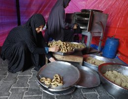 Palestinian women prepare traditional date-filled cookies, or ka'ek, served during Eid al-Fitr, inside a tent in a camp for displaced persons in Deir al-Balah, April 8, 2024. (Photo: Omar Ashtawy/APA Images)
