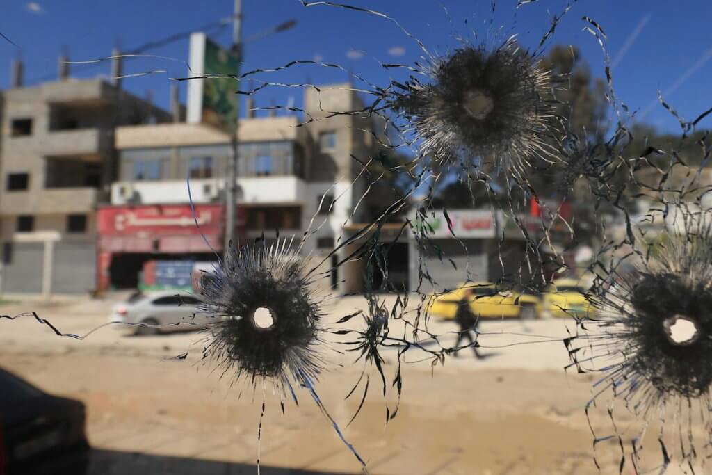 A bullet-riddled window of a damaged shop following an overnight Israeli raid in Nur Shams refugee camp, near the West Bank city of Tulkarem, March 11 2024. The Israeli army had conducted overnight raids in the Nur Shams and Tulkarem camps using a large military force and bulldozers. (Photo: Alaa Badarneh/EFE via ZUMA Press/APA Images)