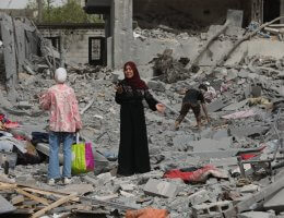 A dismayed Palestinian woman asses the damage on a street in the Nuseirat refugee camp in the central Gaza Strip following the Israeli military's withdrawal from the area.
