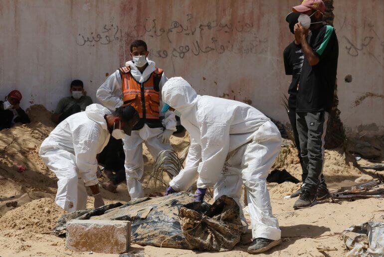 Palestinian health workers unearth bodies at the mass grave near Nasser Hospital, Khan Younis, April 21, 2024. (Photo: Omar Ashtawy/APA Images)