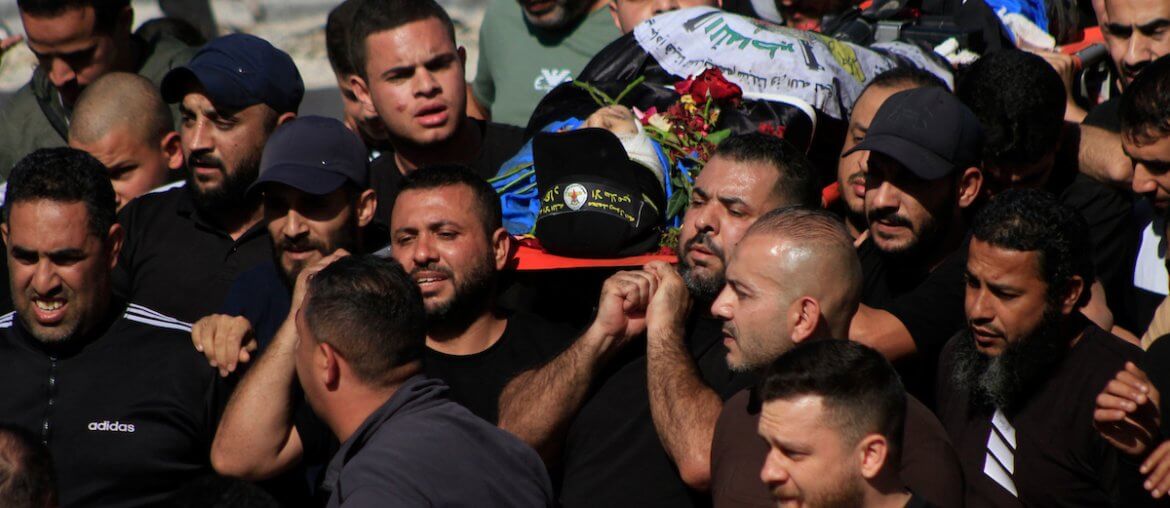 Mourners carry the bodies of Palestinian men killed in an Israeli raid in the Nur Shams camp during their funeral procession in the occupied West Bank city of Tulkarem, on April 21, 2024. (Photo: Mohammed Nasser/APA Images)