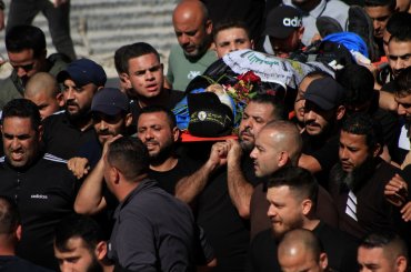 Mourners carry the bodies of Palestinian men killed in an Israeli raid in the Nur Shams camp during their funeral procession in the occupied West Bank city of Tulkarem, on April 21, 2024. (Photo: Mohammed Nasser/APA Images)