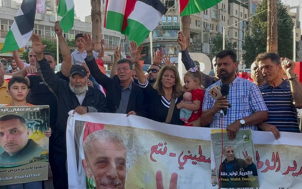 A demonstration in Ramallah in solidarity with Walid Daqqah, August 26, 2023. Pictured in the middle is Daqqah's wife, Sana' Salameh, carrying their daughter, Milad Daqqah. (Photo: Ahmad Arouri/APA Images)