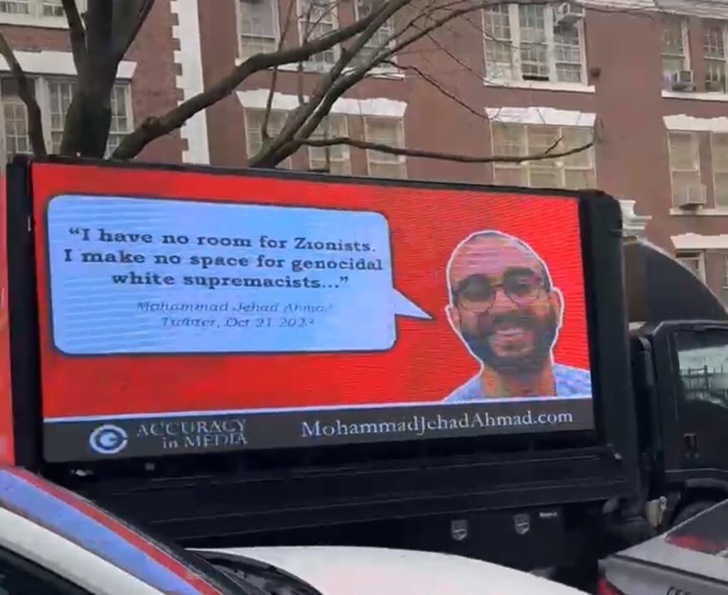 A doxing truck driving through New York City with Mohammad Jehad Ahmad's face and tweet displayed. 