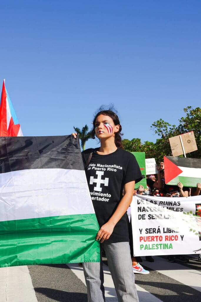 A protestor stands holding a Palestinian flag in Viejo San Juan on Dec. 30 of 2023.