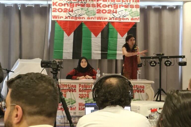 Hebh Jamal (seated) giving the opening address at the Berlin Palestine Congress shortly before it was shut down by German authorities. (Photo courtesy of author)