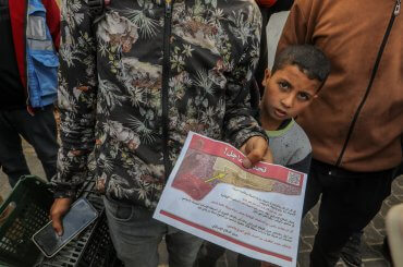 Palestinians holds a leaflet dropped by the Israeli army on eastern Rafah, ordering them to evacuate and move towards the west of the city and the city of Khan Younis, May 6, 2024. (Photo: © Abed Rahim Khatib/dpa via ZUMA Press/APA Images)