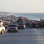 Crowds of displaced Palestinians travel in cars and on foot away from Rafah in the southern Gaza Strip. (APA Images)