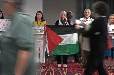 Pastors, students, laity, and delegates have a silent protest against the violence in Palestine during the 2024 United Methodist General Conference in Charlotte, N.C. Tuesday April 30, 2024. (Photo by Larry McCormack, UM News)