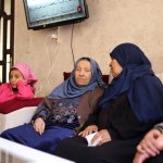 Amira Hajjaj, 72, (center), at her home with relatives in al-Shuja'iyya in 2022. (Photo: Tareq Hajjaj)
