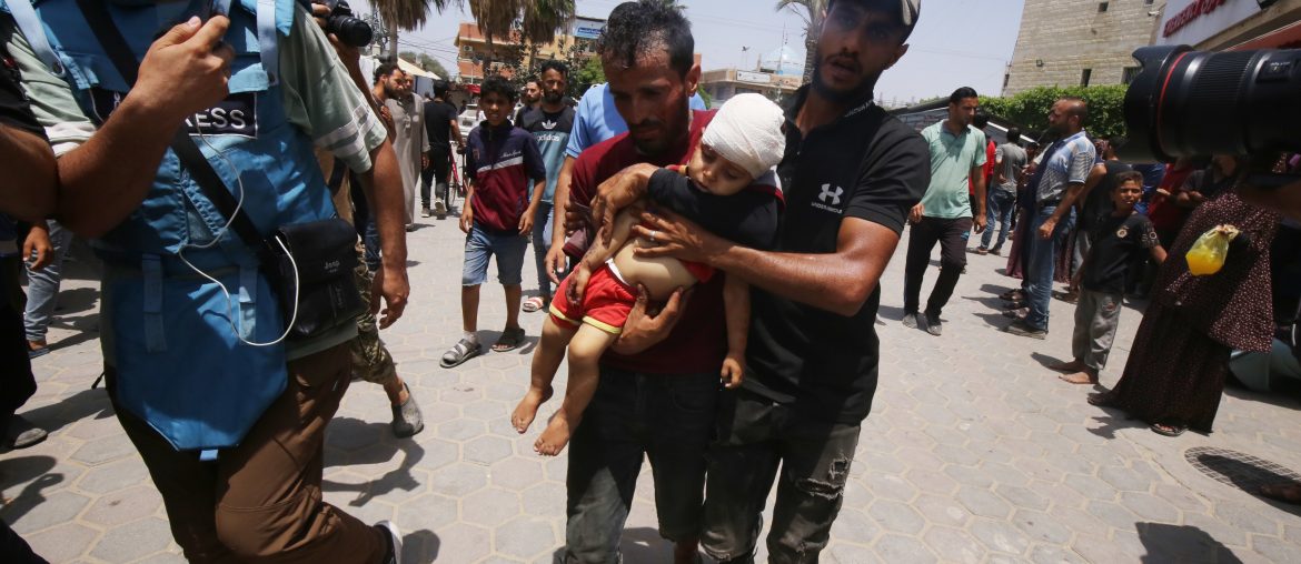 An Injured Palestinian child is carried into the Al-Aqsa Martyrs Hospital in Central Gaza.