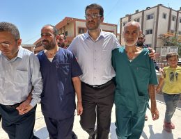 Al-Shifa Hospital director Muhammad Abu Salmiyya, second left in blue scrubs, in Khan Younis after his release from Israeli jail since his detainment in November, Nasser Hopsital, July 1, 2024. (Photo: Moaz Taha/APA Images)