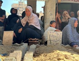 Palestinians gather as Civil Defense workers exhume 12 bodies from a mass grave inside the Al-Amal Hospital of the Red Crescent Society in Khan Younis, southern Gaza Strip, July 18, 2024. (Photo: Abdullah Abu Al-Khair/APA Images)