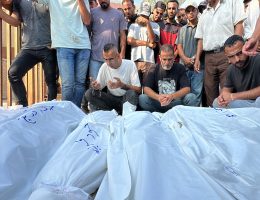 Mourners recite a prayer over the bodies of members of the Qadih family, before their burial in Khuzaa in the southern Gaza Strip, following an overnight Israeli strike that hit their house in Bani Suheila, reportedly killing two children, their father, uncle, paternal grandparents and severely injuring their mother, on July 21, 2024. (Photo: Abdullah Abu Al-Khair / APA Images)