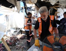 Palestinian first responders assess the damage after a tent marked as 'press' was targeted in an Israeli attack in the central Gaza Strip.