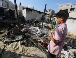 A Palestinian boy looks at the rubble of burned tents that were targeted by an Israeli bomb.