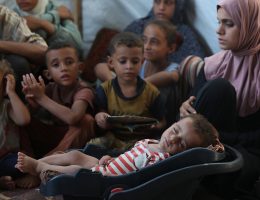 Palestinian infant Abdul Rahman Abu Al-Jidyan, 11 months, who contracted polio, receives care from his mother and family inside a tent in a shelter for displaced people west of El-Zawaida in central Gaza Strip, on August 27, 2024. (Photo: Naaman Omar/APA Images)