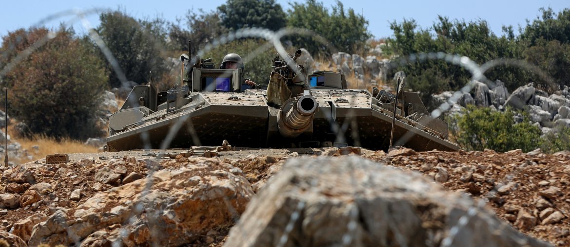 An Israeli tank is seen stationed behind barbed wire on the Lebanese border near the village of Kfarchouba (Photos: © Marwan Naamani/dpa via ZUMA Press/APA Images)