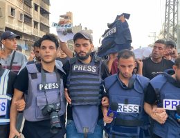 Mourners and colleagues surround the bodies of Al-Jazeera Arabic journalist Ismail al-Ghoul and cameraman Rami al-Refee, killed in an Israeli strike during their coverage of Gaza's Al-Shati refugee camp, on July 31, 2024. (Photo: Hadi Daoud/APA Images)