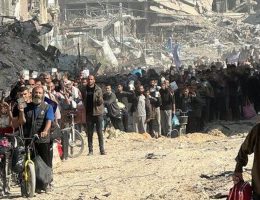 A crowd of Palestinians holding up their ID cards are forced to pass through an Israeli army checkpoint near Jabalia at gunpoint. (Photo: Social Media)