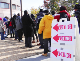 People standing in line to vote with voting sign displayed, Washington, D.C. (Photo: OSCE/Thomas Rymer)