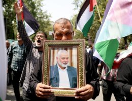 A protester at Tehran University carries a picture of the dead Hamas leader Ismail Haniyeh. (Photo: Abedin Taherkenareh/EPA)