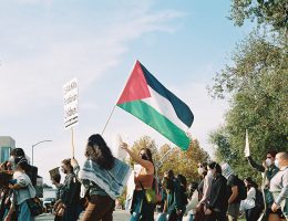 Protesters carry a Palestinian flag at The University of California, Davis. (Photo by Jennie Rose Nelson, 35mm color film)