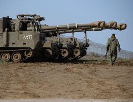 An Israeli soldier walks past M109 155mm self-propelled howitzers in the Israeli-occupied Golan Heights near the Syrian border in 2023. (Image: Ayal Margolin/Jini/Xinhua via ZUMA Press/APAIMAGES)