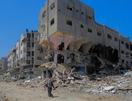 A Palestinian woman walks past buildings destroyed in Israeli strikes in the southern Gaza Strip city of Khan Younis, on April 12, 2024. (Credit Image: © Rizek Abdeljawad/Xinhua via ZUMA Press APAimages)