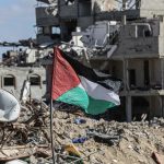 A Palestinian flag stands amid the rubble in the Gaza Strip on January 20, 2025. (Photo: Omar Ashtaw/ APA Images)