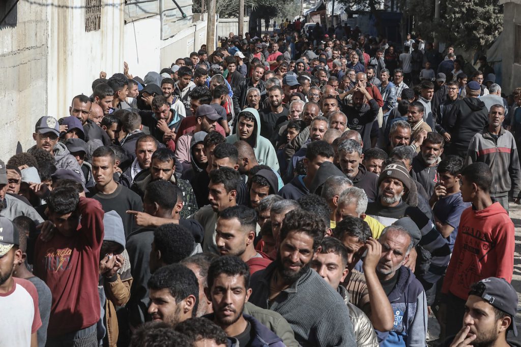 People wait in crowded lines for hours to buy bread at a bakery operating in Deir al-Balah after the Israeli forces allowed limited amounts of flour and fuel into the city in the central Gaza Strip, on November 21, 2024. (Photo: Omar Ashtawy/APA Images)