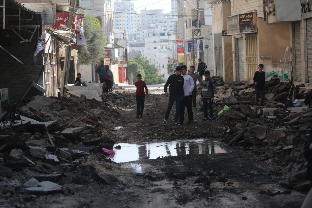 Palestinians in the Tulkarem refugee camp walk down a street destroyed by Israeli bulldozers in a raid in late January 2025. (Photo by Mohammed Nasser apaimages)