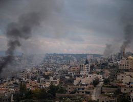 Smokes rises above Jenin refugee camp as Israeli colonial forces continue to raid Jenin and the camp for a fourth day as part of a major military operation to crack down on armed resistance, January 24, 2025. Israeli armed bulldozers have entered the camp, destroying infrastructure and homes. Witnesses report that some houses are being burned by Israeli forces. Drones are constantly hovering over the camp, observing as many Palestinian families were forced to flee in the past few days. Entrances and exits are blocked by the Israeli forces, preventing health workers and journalists from entering the refugee camp. At least 12 Palestinians have been killed and nearly 40 injured in Israel's assault on Jenin. (Photo: Wahaj Bani Moufleh/Activestills)